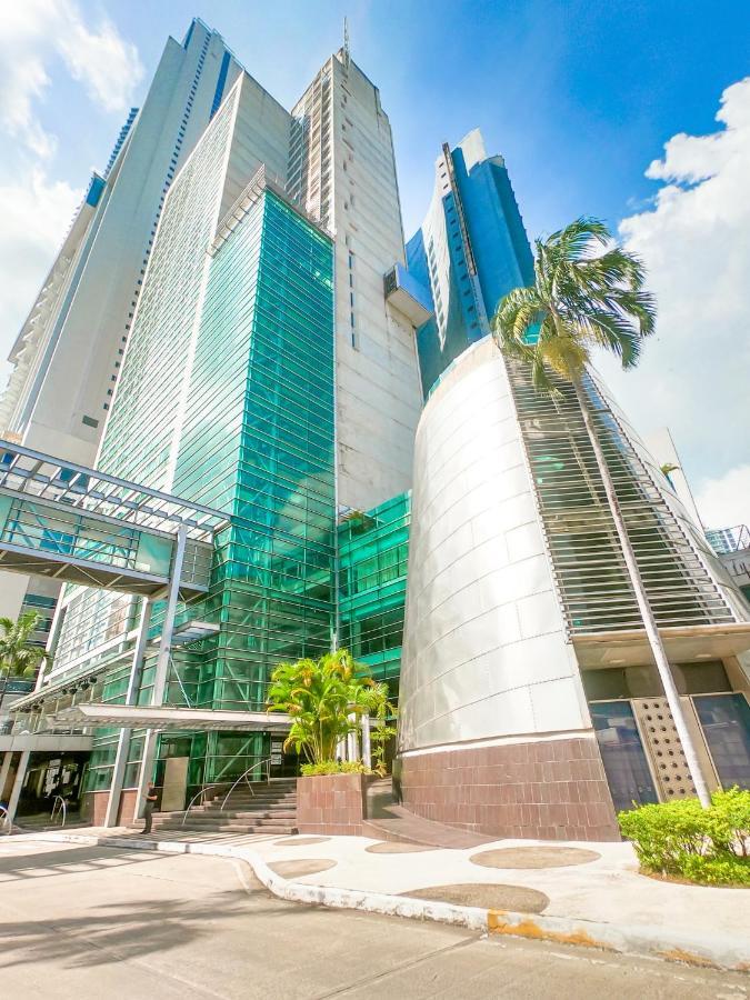 Decapolis Hotel Panama City Exterior photo The photo shows a modern building characterized by its sleek, contemporary architecture. The structure features large glass panels that reflect sunlight, giving it a bright appearance. Part of the building has a curved metallic surface which contrast